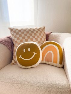 two pillows sitting on top of a couch next to each other