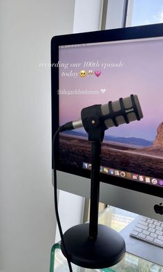 a computer monitor with a microphone attached to it