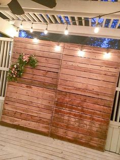 a wooden fence with lights on it