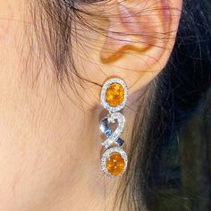 ENJOY OUR WORRY-FREE SERVICE AND THE DAZZLING, GENUINE JEWELRY WE DESIGN AND HANDCRAFT WITH LOVE❤️ ABOUT THE ITEM: SPARKLING! SHIMMERING, DANGLING VIVID ORANGE YELLOW SAPPHIRE EARRINGS! SO PRECIOUS! CERTIFIED 12.68 Total Carats, with 4 pieces of Thai yellow sapphires and 1.21 carats of F/VS, natural diamonds, set in handmade 10.0 grams, 18K solid white gold, CHIC dangling earrings. One of a kind! At 3.6 centimeter in drop length, perfect for both formal and causal events! ONE OF A KIND HANDCRAFT Luxury Oval Gia Certified Earrings, Luxury Hallmarked Oval Diamond Earrings, Luxury Oval Diamond Earrings With Gemstones, Exquisite Oval Diamond Earrings For Anniversary, Exquisite Oval Earrings With Elegant Design, Luxury Citrine Earrings, Luxury Oval Earrings For Anniversary, Yellow Oval Fine Jewelry Earrings, Luxury Oval Diamond Earrings For Gift