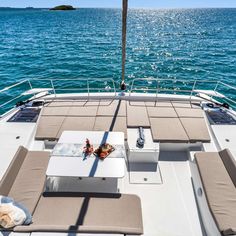 an outdoor lounge area on the back of a boat