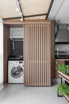 a washer and dryer in a room with wooden slats on the walls