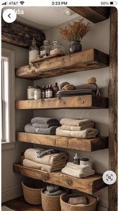 the shelves in this bathroom are made out of wooden planks and have baskets on them