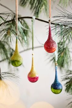 christmas ornaments hanging from a pine tree