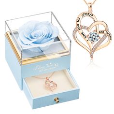 two heart shaped necklaces in a box with a blue rose on the inside and an open one