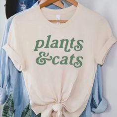 Cats and Plants shirt, Plant Shirt, Gardener t-shirt, gift for plant lover, Cat lover shirt, Retro plants shirt, Plant lady, Plant Mom Discover the purr-fect blend of your two favorite things with our Cats & Plants unisex T-shirt! This trendy and comfortable tee is a must-have for any cat lover and plant enthusiast. Made with high-quality, soft bella canvas, it features a charming graphic that creatively combines adorable cats with lush green plants. Available in a variety of sizes and popular c Plant Mom Shirt, Plant Tshirts, Farmstand Recipes, Cats Plants, Gift For Plant Lover, Cat Plants, Cat Lover Shirt, Adorable Cats, Plant Lover Gift