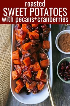 sweet potatoes and cranberries in a white dish with spoons on the side