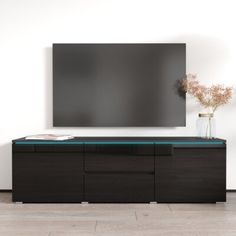 a large flat screen tv mounted to the side of a wooden cabinet in front of a white wall