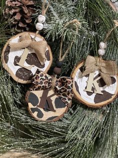 two wooden ornaments hanging from a christmas tree