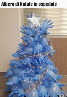 a blue christmas tree with silver and white decorations