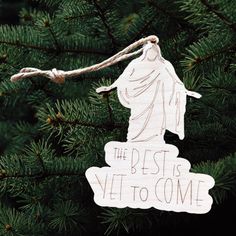 a wooden ornament hanging from a tree with the words, the best is yet to come