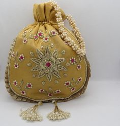 golden zarodsi pearl beaded indian traditional embroider wedding favor bag | indian bridal handbag potli bag | designer handbag for womanMaterial: SilkPackage Contents: As per quantity purchasedSize: 10” x 8”Designed with the heart, this beautiful Potli or batawa bag are eye catchy and made of premium material.Key Features:Embroidery art workThis potli is good match with both Indian and western outfits and are superb for wedding and festive partiesThis would be best complement to your designer s Bridal Handbag, Potli Bag, Bridal Handbags, Kutch Work, Vintage Evening Bags, Step By Step Crochet, Creation Crafts, Potli Bags, Wedding Favor Bags