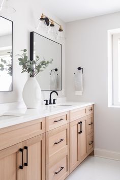 a bathroom with two sinks and a large mirror