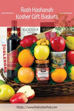 the rosh hashah kosher gift basket is filled with apples, oranges and other