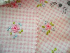 some pink and white checkered fabric with flowers on it