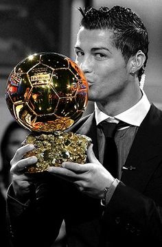 the man is kissing the ballon d'or trophy