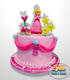 a pink birthday cake decorated with stars and princess figurines on the top tier