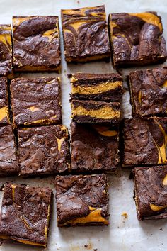 chocolate brownies with yellow frosting on a baking sheet ready to be cut into squares