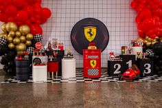 a room filled with balloons and decorations for a ferrari themed birthday party or baby's first birthday