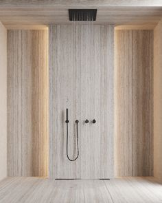 a shower head in the middle of a room with wooden walls and floor to ceiling tiles