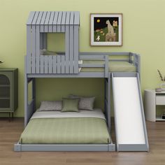 there is a bunk bed with a slide on the bottom and green walls in the background