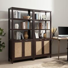 a computer desk and bookcase in a room with a rug on the floor next to it