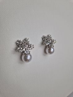 Cute Snowlake stud earrings with cubic zirconia crystals and faux pearls. Glamorous Cubic Zirconia Pearl Earrings, White Cubic Zirconia Pearl Earrings With Sparkling Stones, Pearl Embellished Cubic Zirconia Wedding Earrings, Luxury Silver Pearl Embellished Earrings, Pear-shaped Cubic Zirconia Pearl Earrings, Luxury Bridal, Bridal Earrings, Jewelry Earrings Studs, Faux Pearl