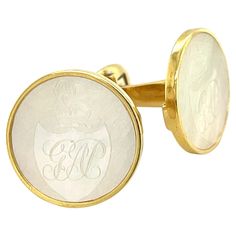 Custom-made cufflinks - for the man who has (almost) everything! These handmade 18k yellow gold cufflinks feature a beautiful pair of mother-of-pearl antique gaming counters that were originally carved in China in the 1800's. Hand-carved gaming counters were commissioned by the British and used as gambling chips the way poker chips are used in the United States. This particular pair of 19mm rounds were cut from fine quality chips that have excellent luster and pearlescence and show a family crest with the initials, "GAP." These cufflinks were handcrafted in 18k yellow gold with custom-made bezels and an oval mechanism that has been hand engraved with an ornamental leaf pattern and an elegant textured finish. The cufflinks measure 3/4" in diameter. The perfect finishing touch for a gentlema Gambling Chips, Gold Cufflinks, Poker Chips, Mother Pearl, Family Crest, Cuff Links, Hand Engraving, Leaf Pattern, Mother Of Pearl