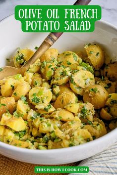 a white bowl filled with potatoes and herbs