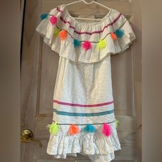 Ocean Drive Aztec Tassel Trim Tube Dress In White Women’s Size Large So Fun Off The Shoulder Or On Tassel Tube Dress Embellished With Fluorescent Tassels Embroidered Trim Around The Bottom And The Neck Ruffled Neck And Hem High/Low Design. Hem Is Slightly Higher In The Front Than The Back Unlined 100% Cotton Perfect For A Caribbean Cruise Or A Summer Party New With Tags And In Perfect Condition Comes From A Smoke Free Home Multicolor Sleeveless Fringe Dresses, Casual White Dresses With Tassel Ties, Casual White Dress With Tassels, Casual White Tassel Dress, Casual White Dress With Tassel Ties, Multicolor Fringe Dress For Beach, Multicolor Fringe Beach Dress, Multicolor Fringe Dresses For Summer, Multicolor Fringe Dress For Summer