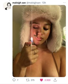 a woman wearing a fur hat and holding a lighter