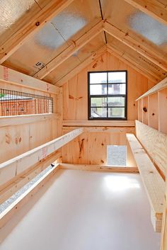 an empty room with wooden walls and windows