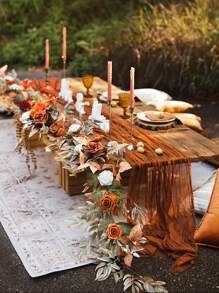 a long table is set up with candles and flowers on it for an outdoor dinner