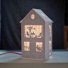 a paper house that has been cut out to look like it is lit up at night