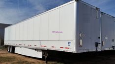 a white semi truck parked in a field