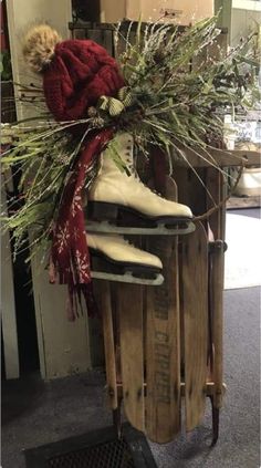 a pair of skis sitting on top of a wooden sled filled with plants