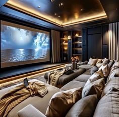 a living room filled with furniture and a large screen