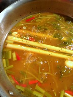 the soup is prepared and ready to be eaten with chopsticks on the side