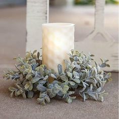 a white candle sitting on top of a table