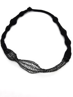 Black knitted necklace made with organic cotton and metal. This jewelry necklace collection is made in collaboration with Karine Nicon, fiber artist based in Douarnenez, France. She does fine knitted arts and jewelry. Here, she mixed for this collection cotton and metal that she knitted together. Due to the hand made process, every piece is slightly different from the next one. Embrace the slight variations knowing your product is truly unique and special. Material : organic cotton & metal Dimen Adjustable Black Handwoven Necklace, Adjustable Handwoven Black Necklace, Knitted Necklace, Wave Necklace, Rocky Shore, Fiber Artist, Sustainable Textiles, Necklace Collection, Crochet Art