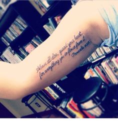 a woman's arm with a quote on it