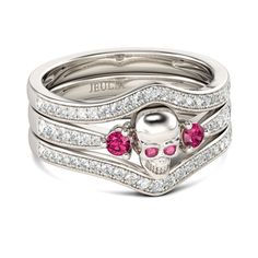 a skull ring with pink stones in the middle and white diamonds on each band,