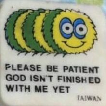 a close up of a magnet with a cartoon character on it's back and the words please be patient god isn't finished with me yet