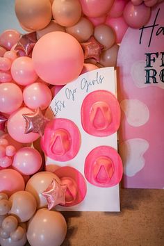 pink and white balloons, star shaped cookie cutters, and a happy birthday card