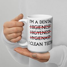 a woman holding a coffee mug with the words i'm a dental hygiene engineer, i clean teeth