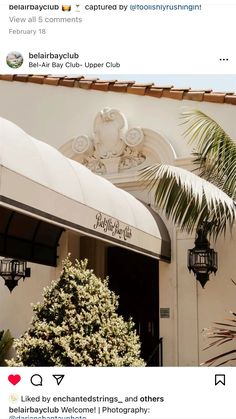 an image of a building with palm trees in the background