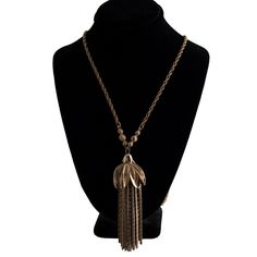 A vintage gold plated tassel necklace. The tassel cap is adorned with rhinestones. A few of them are missing but it isn't very noticeable. The plating shows a little wear but otherwise the piece is in good condition. Perfect for a costume or fun night out! The necklace is 26 inches long and the tassel pendant is 3 inches long. Gold Fringe Metal Necklaces, Gold Fringe Metal Necklace, Adjustable Gold Tassel Necklace With Fringe, Gold Tassel Necklace For Party, Adjustable Gold Fringe Necklaces, Adjustable Gold Necklace With Fringe, Gold Long Fringe Necklace, Gold Tassel Necklace With Adjustable Chain, Gold Metal Tassel Dangle Necklace