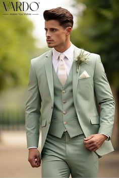 a man wearing a green suit and white shirt is walking down the street with his hand in his pocket