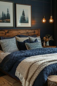 a bed with blue comforter and pillows in a bedroom next to two pictures on the wall