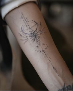 a woman's arm with a tattoo on it and an arrow in the middle